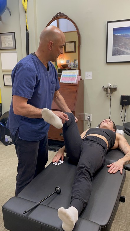 Dr Cohen muscle testing a female patient