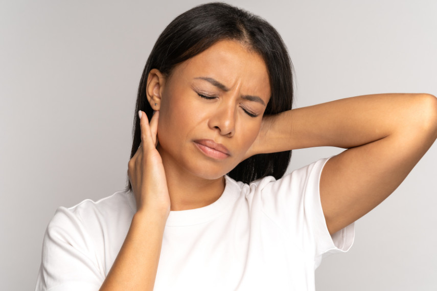 Woman holding her neck in pain