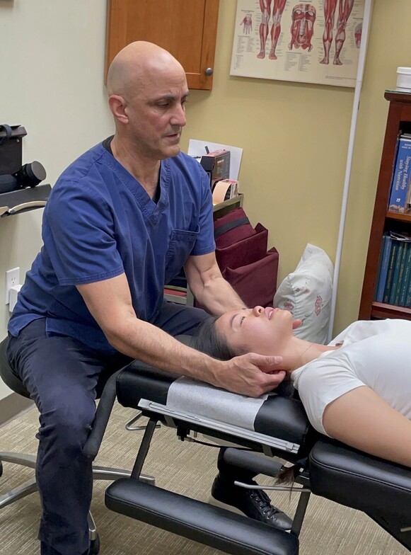 Dr Cohen working on a patient's neck