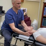 Dr Cohen working on a patient's neck